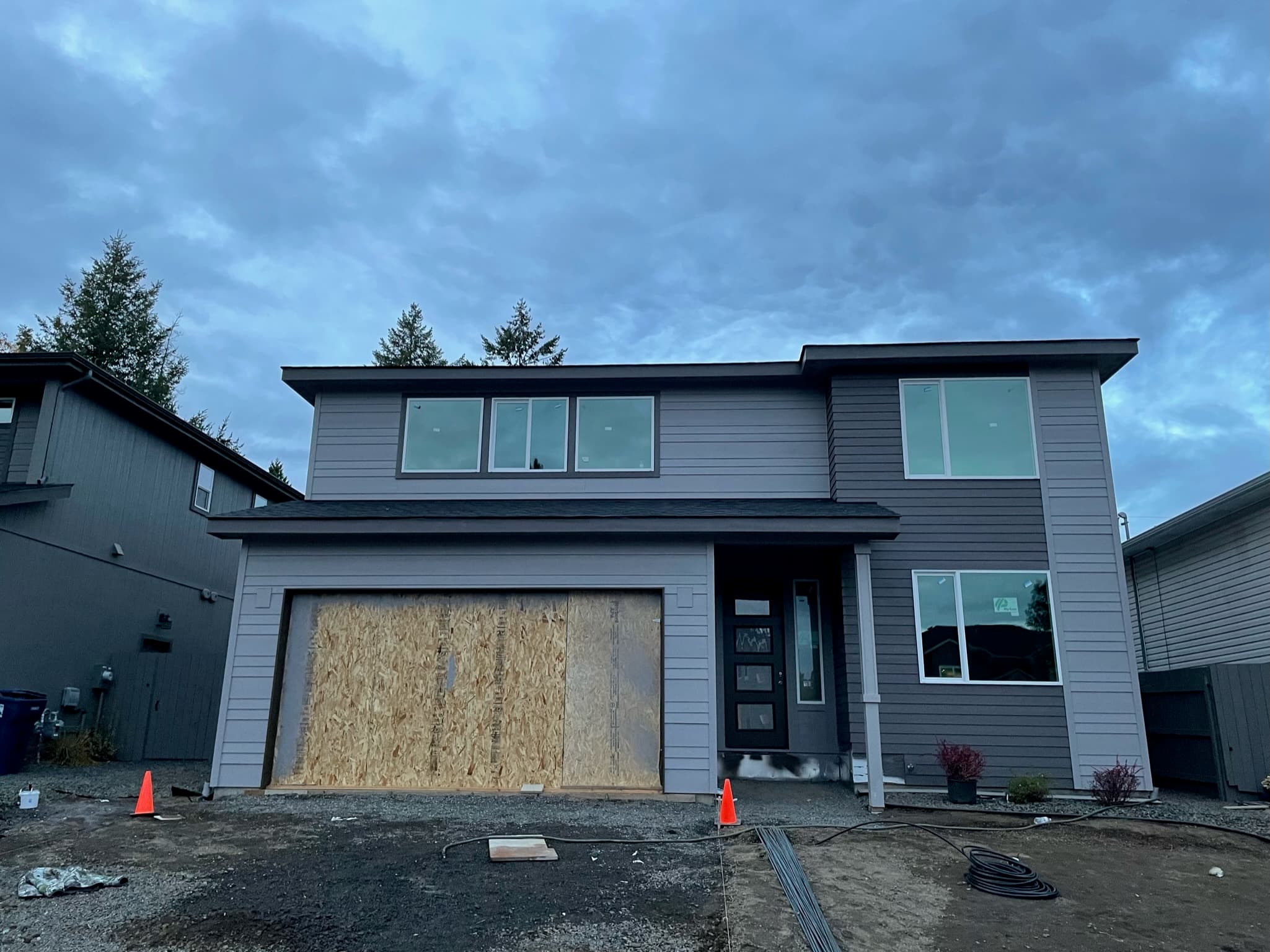 Gray Spokane, WA modern siding repaint in progress on a new home facade