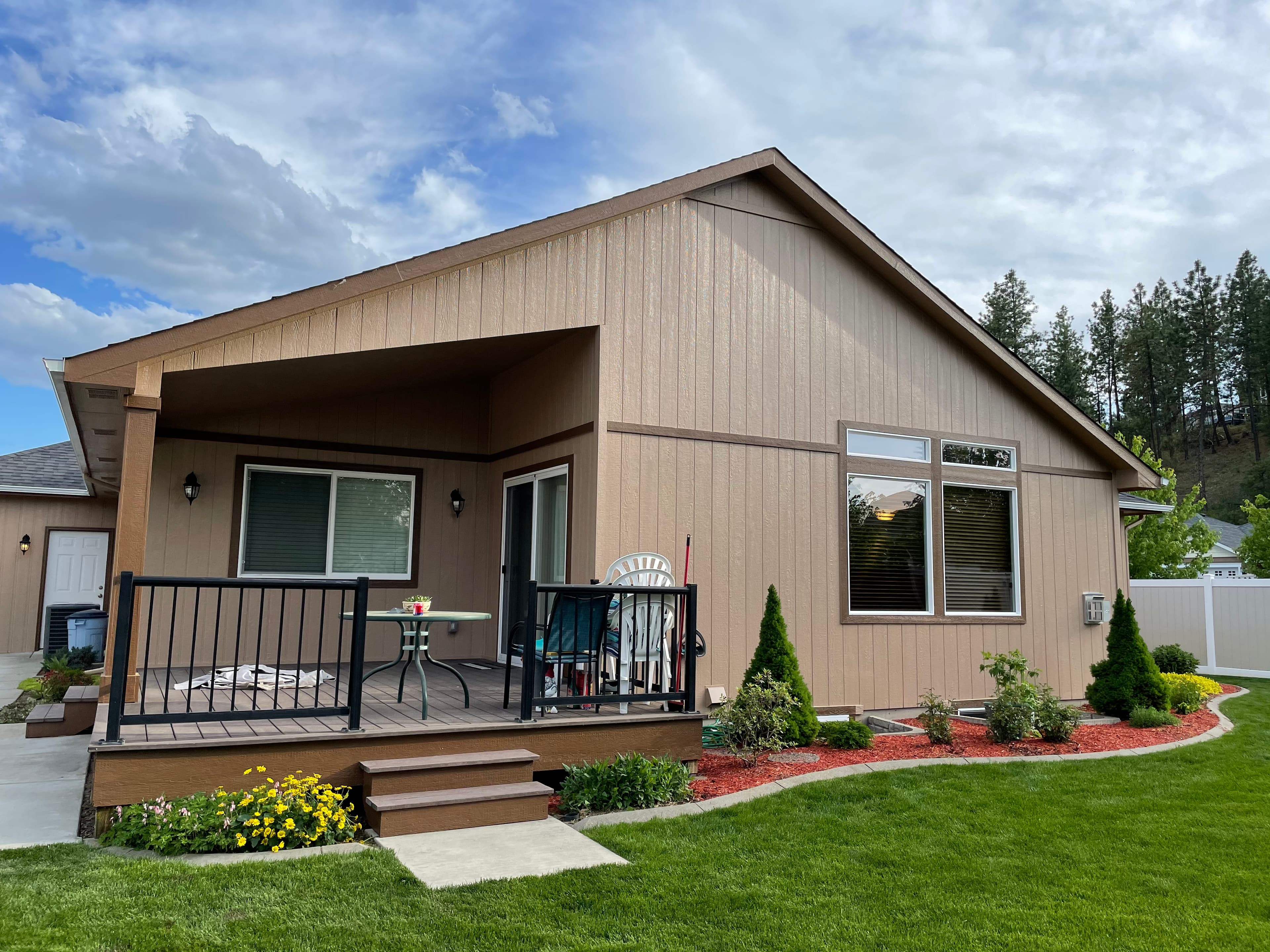 Tan Spokane, WA horizontal siding exterior repaint with covered porch