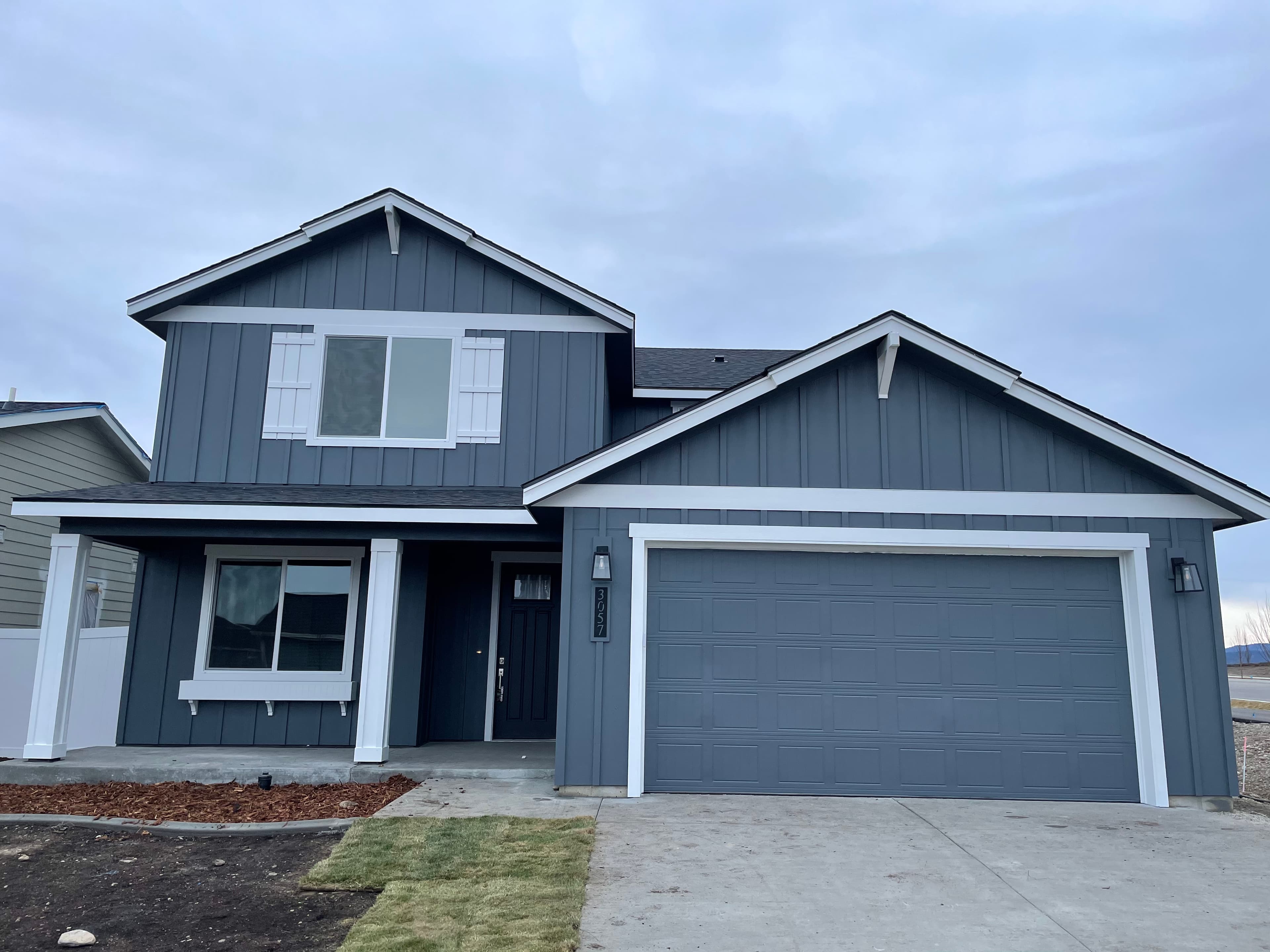 Gray board-and-batten siding exterior repaint on a Spokane, WA farmhouse