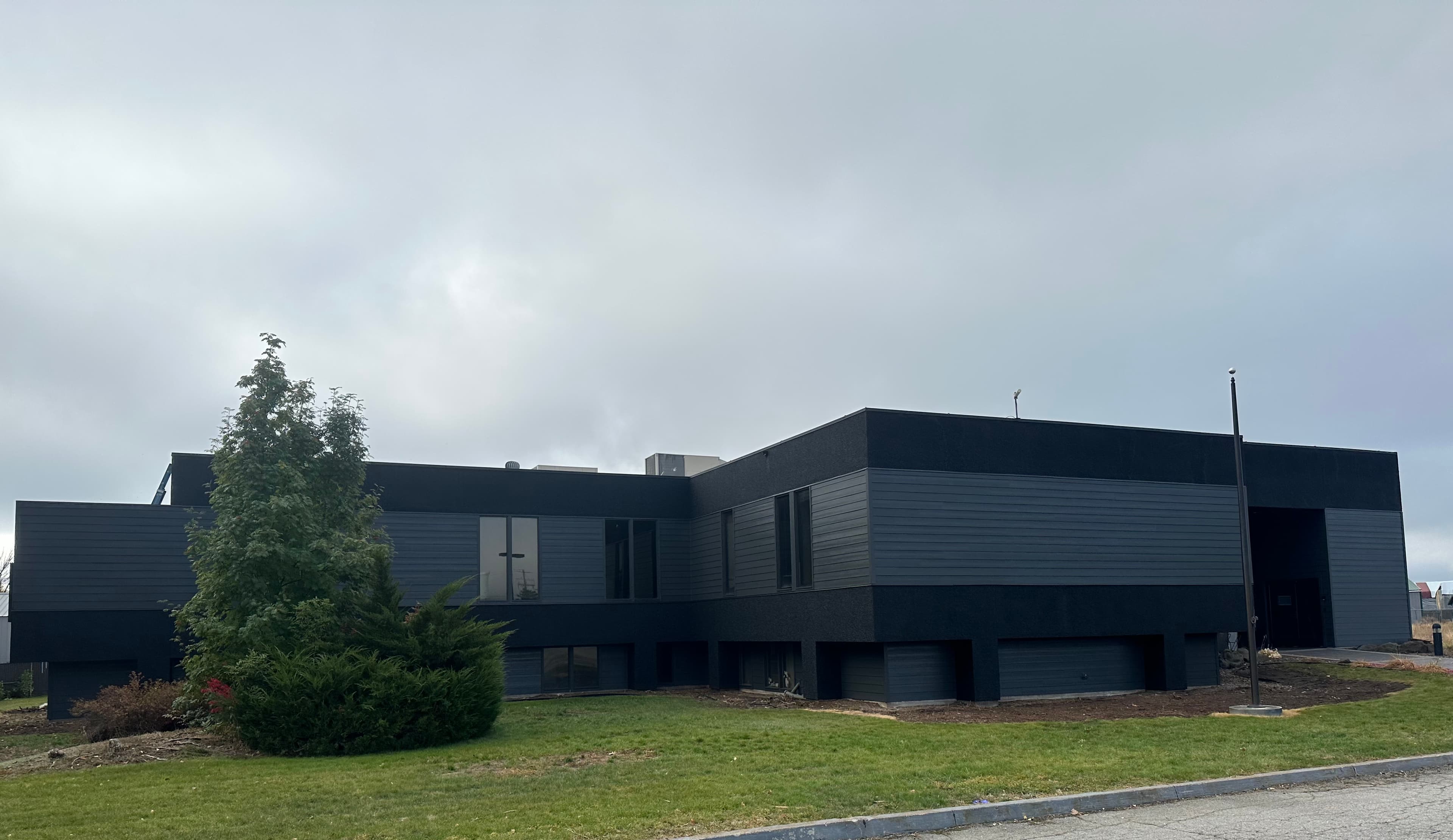 Dark Spokane, WA commercial facade after exterior repaint on a low office building