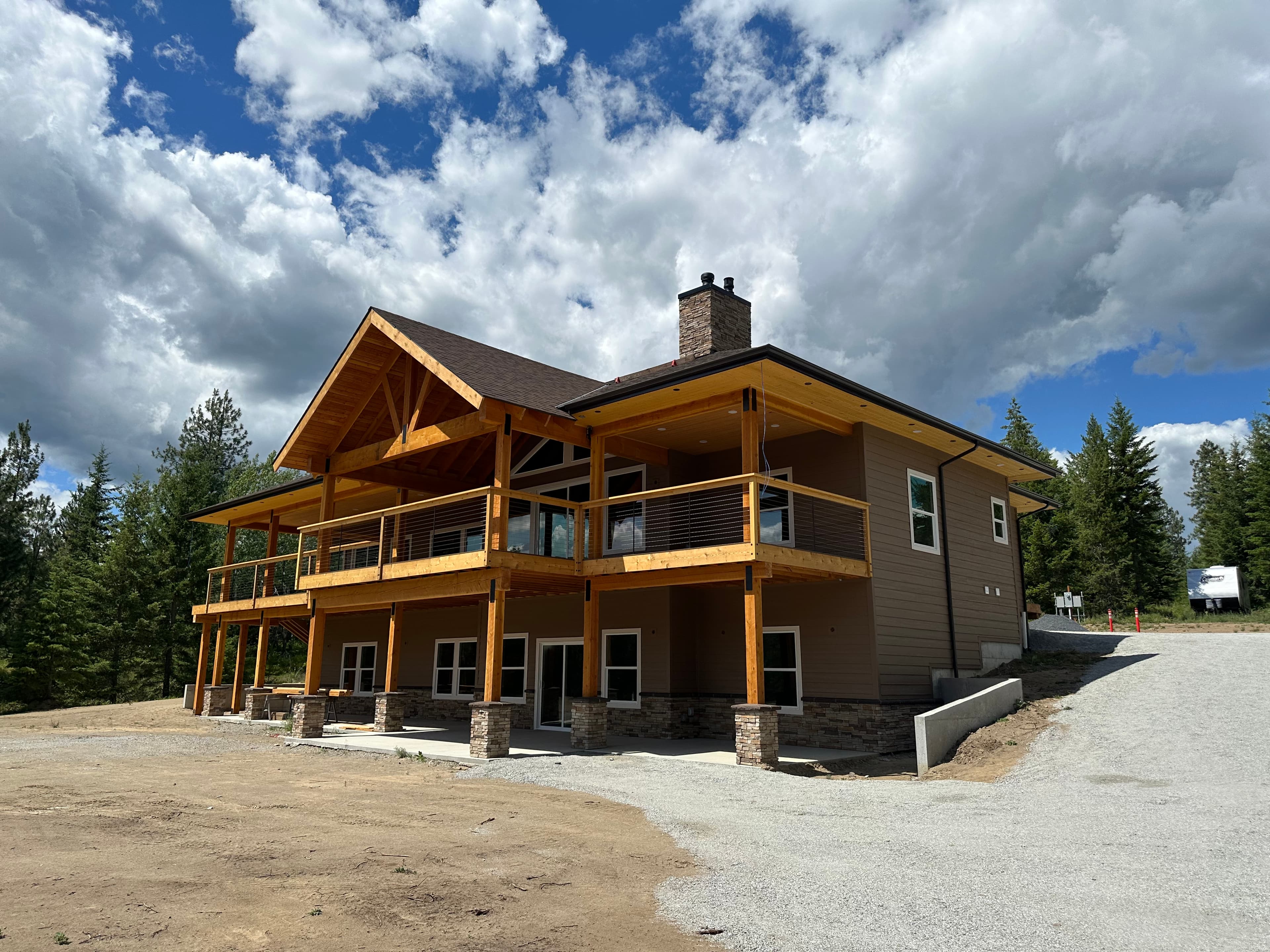 Brown Spokane, WA siding exterior repaint with exposed beam porch supports