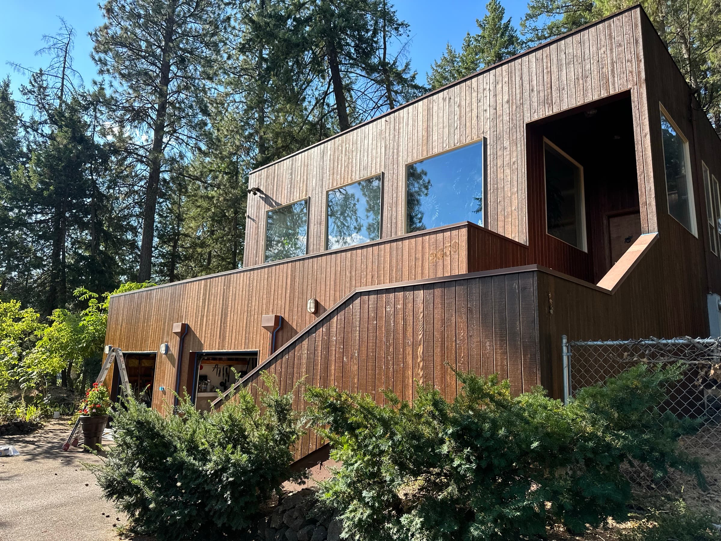 Modern wood siding staining on a forest home near Spokane, WA