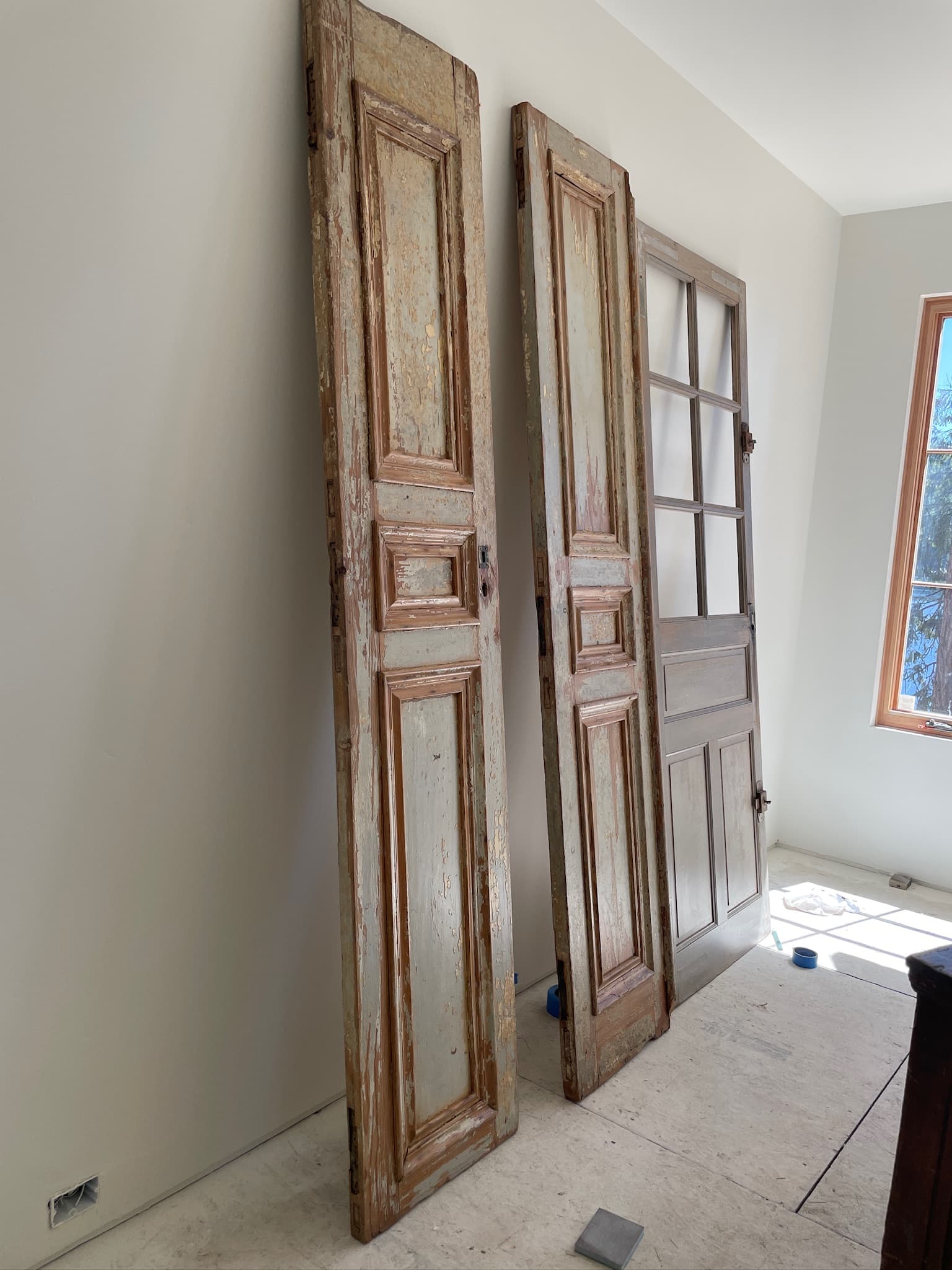 Stripped wood door set staged for refinishing inside a Spokane, WA room