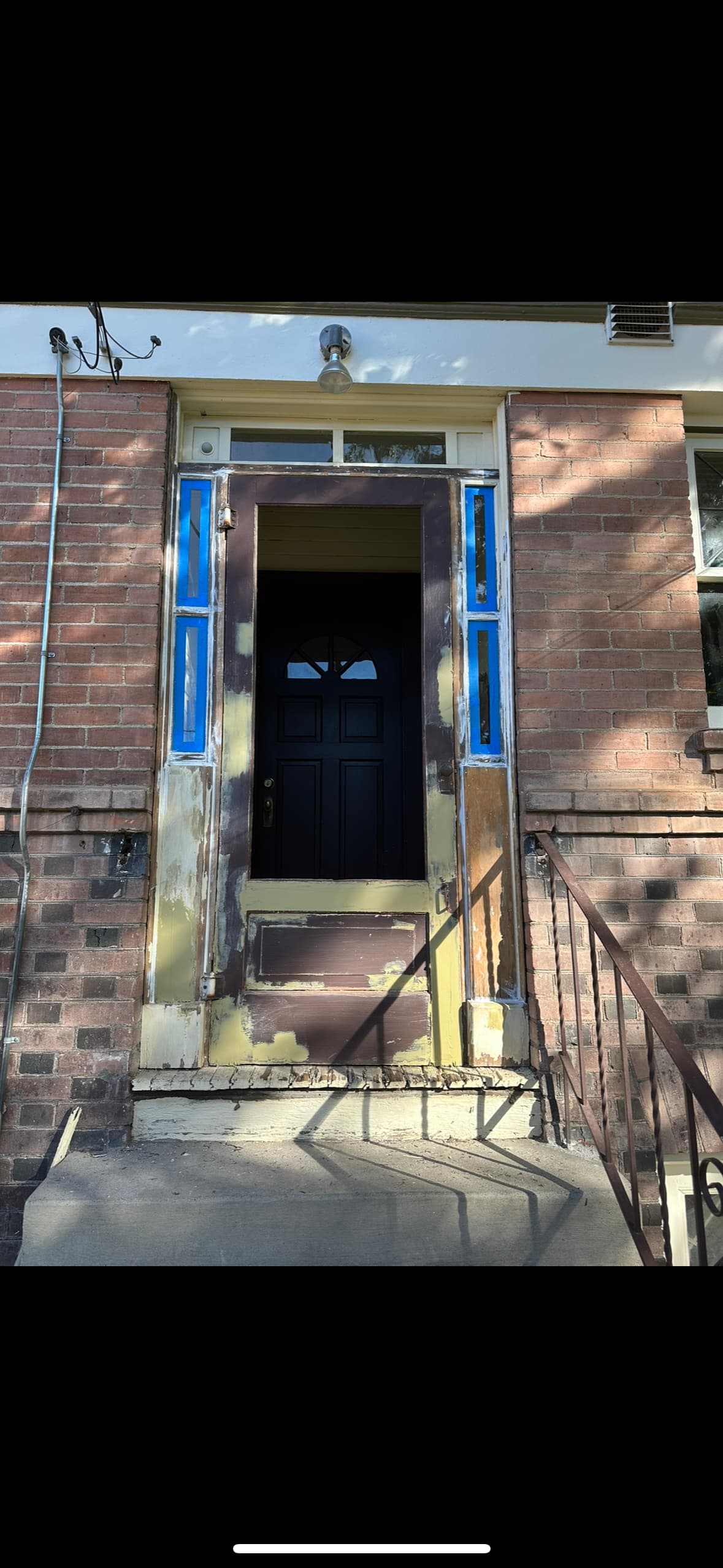 Entry door masked for prep on masonry exterior at a Spokane, WA home