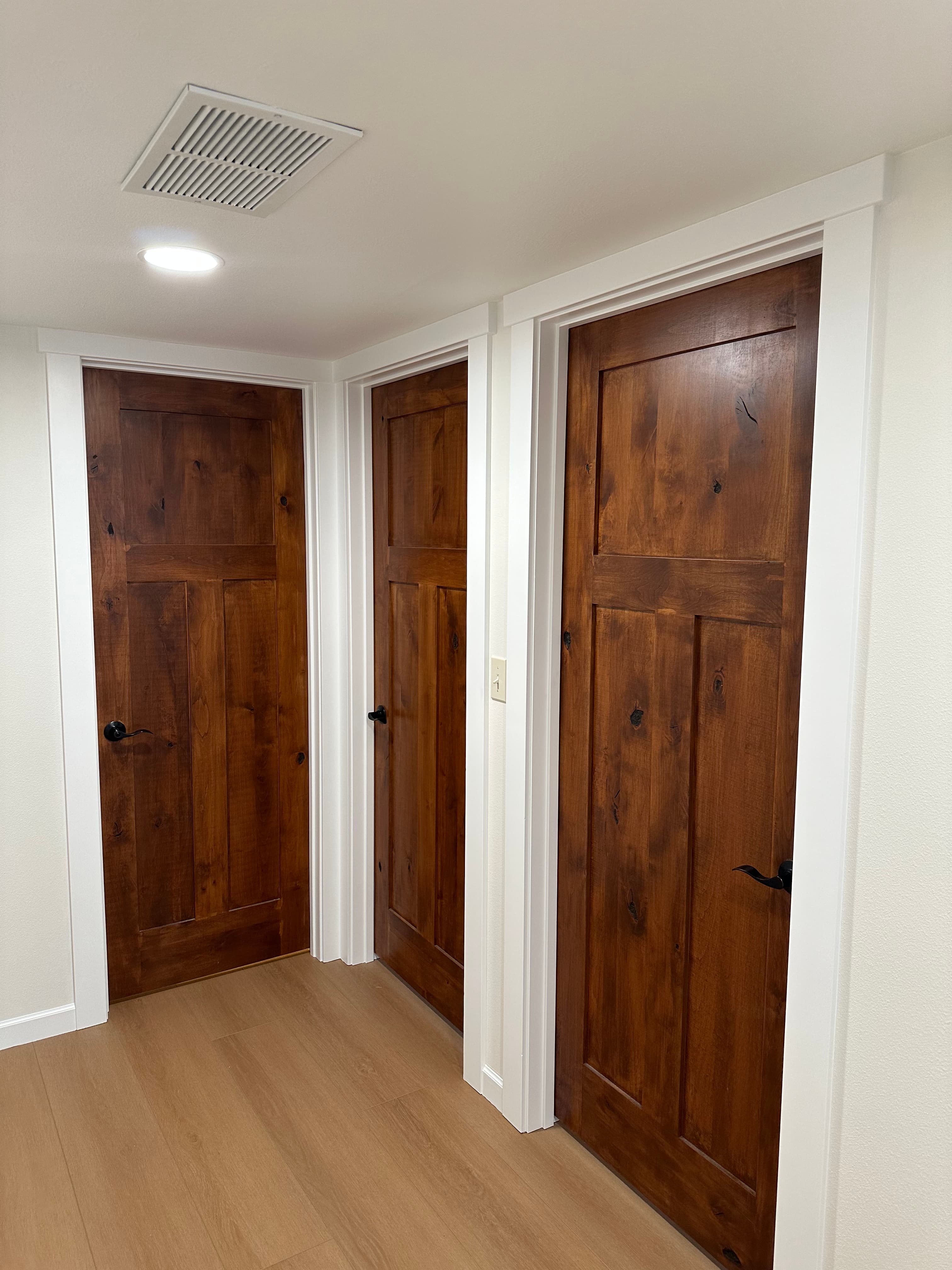 Stained wood door millwork in a bright Spokane, WA hallway